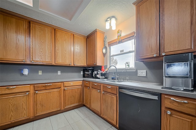 kitchen featuring a sink, brown cabinets, dishwasher, and a textured ceiling