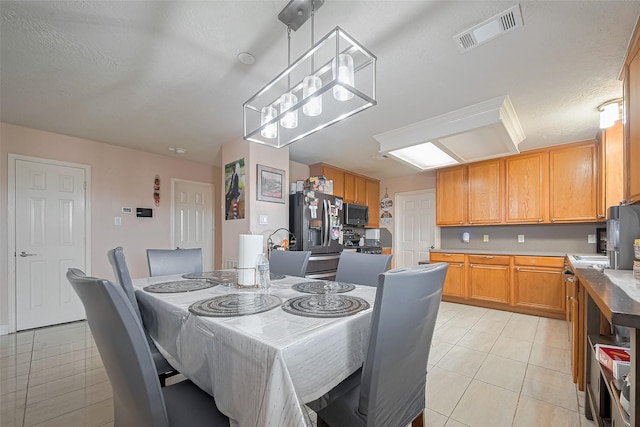 dining room with light tile patterned flooring and visible vents
