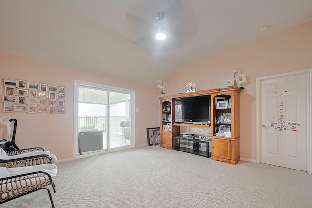 living area featuring baseboards, vaulted ceiling, and carpet