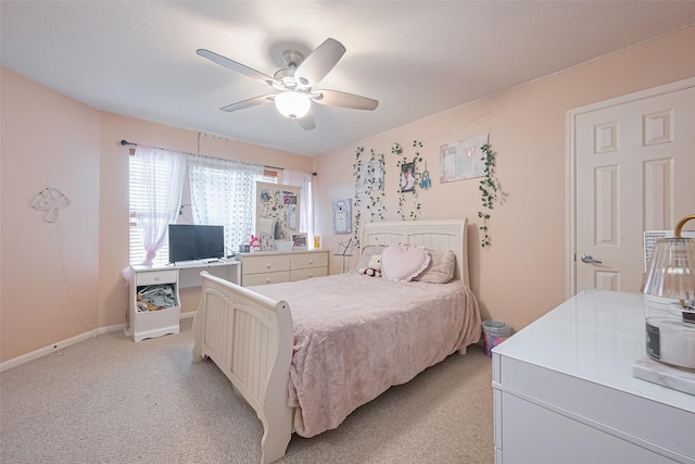 bedroom with light carpet, baseboards, and a ceiling fan