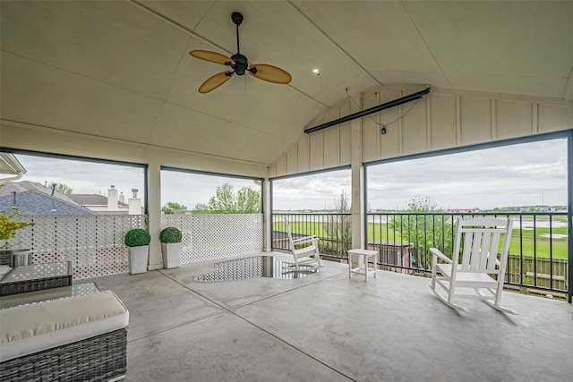 unfurnished sunroom featuring a ceiling fan