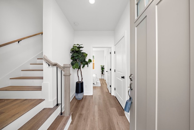 entrance foyer featuring baseboards, light wood-style floors, stairway, and recessed lighting