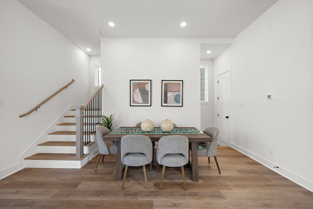dining area with baseboards, light wood-style floors, stairway, and recessed lighting