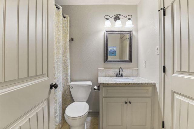 bathroom with toilet and vanity