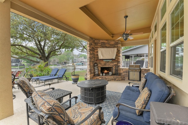 view of patio / terrace with an outdoor living space with a fireplace, a grill, fence, and ceiling fan
