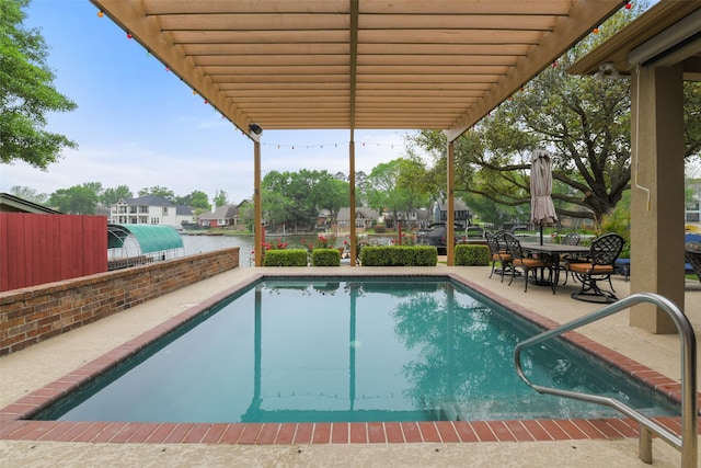 outdoor pool featuring fence and a patio
