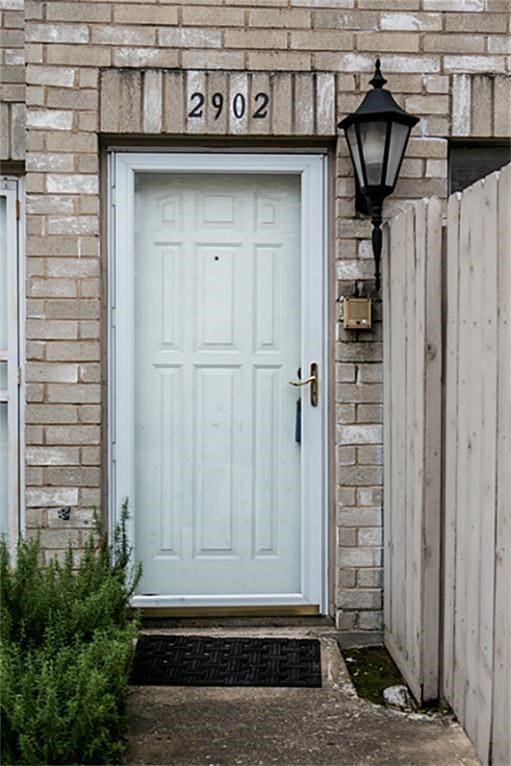property entrance with stone siding