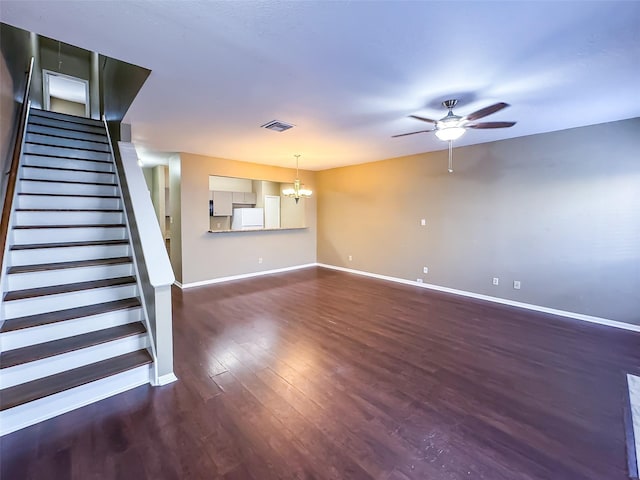 unfurnished living room with visible vents, baseboards, stairs, wood finished floors, and ceiling fan with notable chandelier
