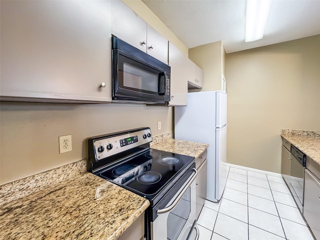 kitchen with light stone counters, light tile patterned floors, and stainless steel appliances