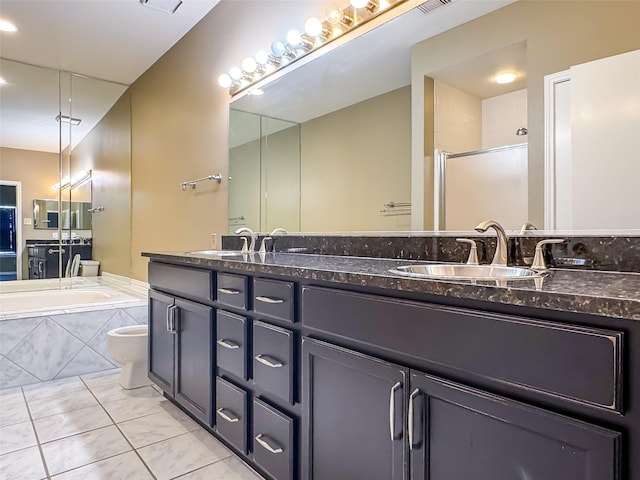 bathroom featuring double vanity, a sink, a bath, and a shower stall