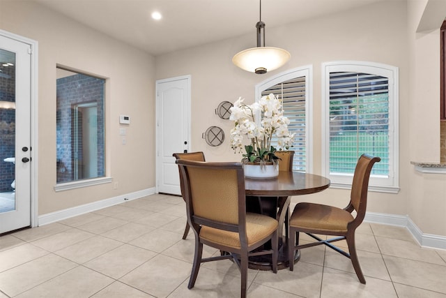 dining area with light tile patterned flooring, baseboards, and recessed lighting