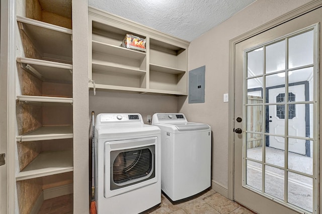 washroom featuring laundry area, washing machine and dryer, a textured ceiling, electric panel, and a wealth of natural light