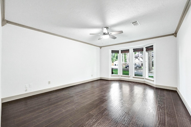 spare room with ceiling fan, a textured ceiling, wood finished floors, baseboards, and ornamental molding