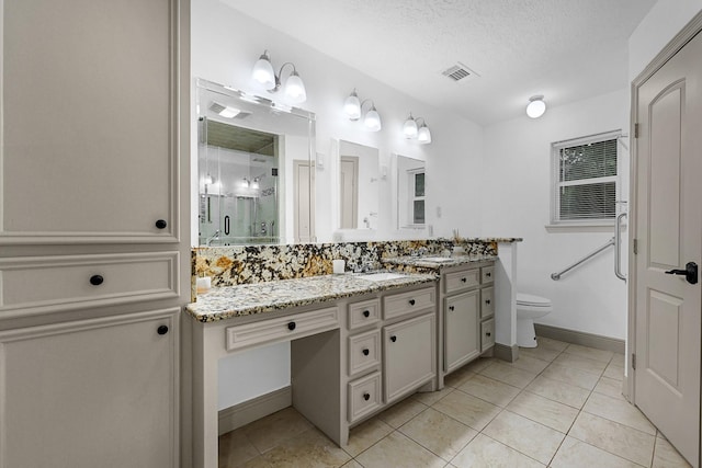 bathroom featuring visible vents, tile patterned flooring, a stall shower, vanity, and toilet