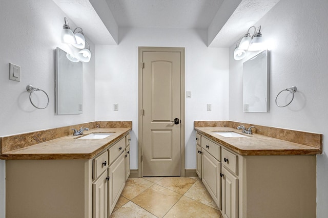 bathroom featuring a sink and two vanities