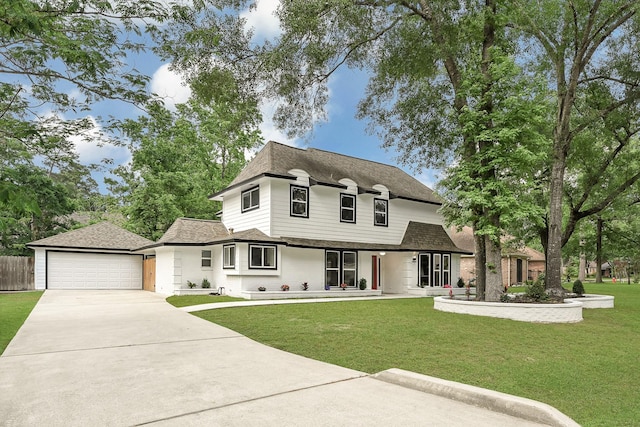 french provincial home with roof with shingles, a porch, driveway, and a front yard