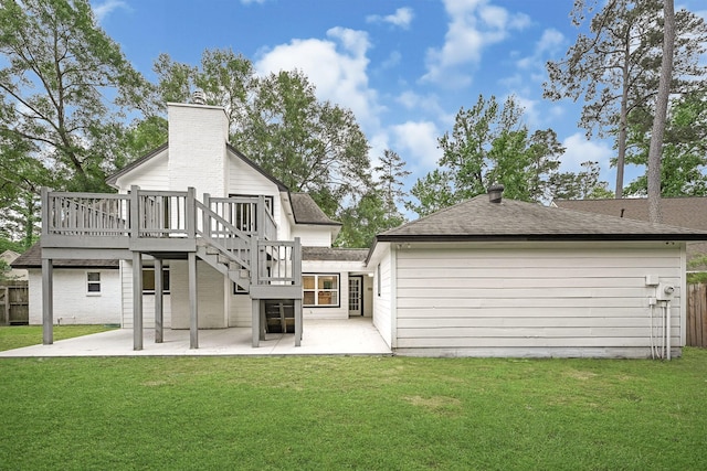 back of house with a patio area, fence, a yard, and a chimney