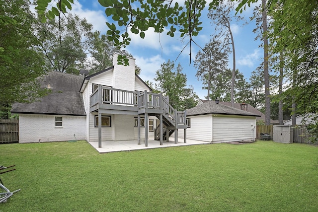 back of property with an outdoor structure, a wooden deck, fence, a patio, and a shed