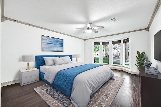 bedroom with crown molding, baseboards, a ceiling fan, and dark wood-style flooring