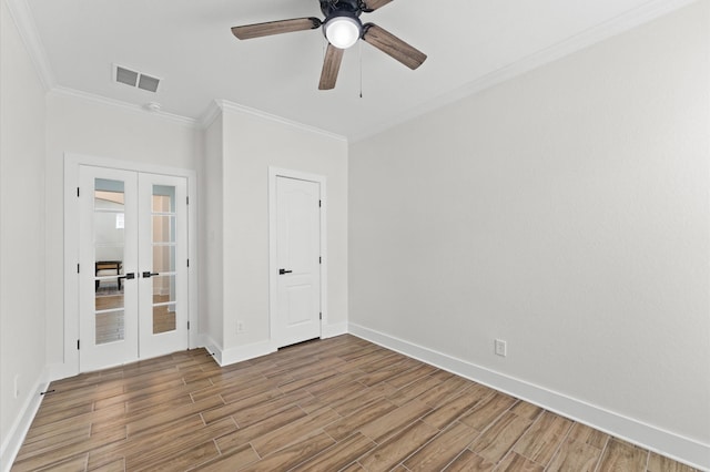 12126 Guadalupe Trail Ln, Humble, TX 77346 - unfurnished bedroom featuring visible vents, crown molding, wood finished floors, and french doors