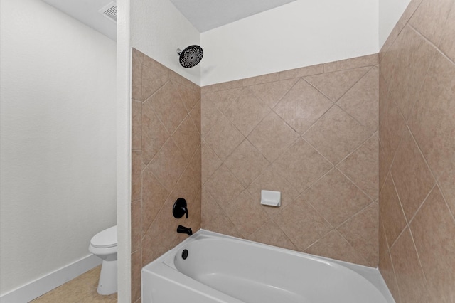 12126 Guadalupe Trail Ln, Humble, TX 77346 - bathroom featuring tile patterned floors, toilet, baseboards, and shower / bathtub combination
