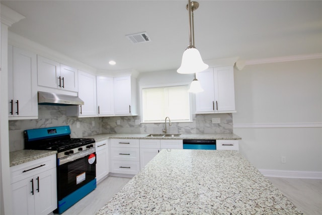 kitchen with stainless steel gas range oven, a sink, under cabinet range hood, dishwashing machine, and light stone countertops