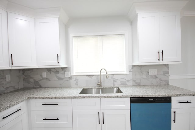 kitchen with dishwashing machine, a sink, backsplash, and white cabinets