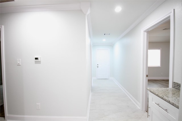 corridor with ornamental molding, baseboards, and recessed lighting