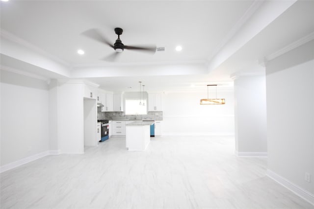 unfurnished living room with a tray ceiling, a ceiling fan, ornamental molding, recessed lighting, and baseboards