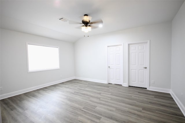 unfurnished bedroom featuring dark wood-style floors, baseboards, and a ceiling fan