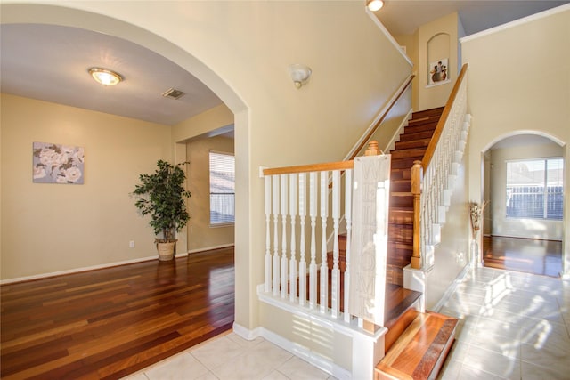 21122 Covington Bridge Dr, Spring, TX 77388 - stairway with arched walkways and tile patterned floors
