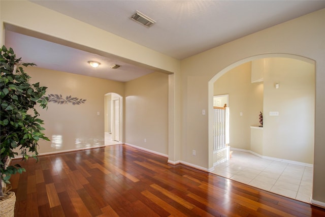 21122 Covington Bridge Dr, Spring, TX 77388 - empty room with arched walkways and hardwood / wood-style flooring