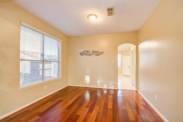 21122 Covington Bridge Dr, Spring, TX 77388 - empty room with arched walkways and wood finished floors