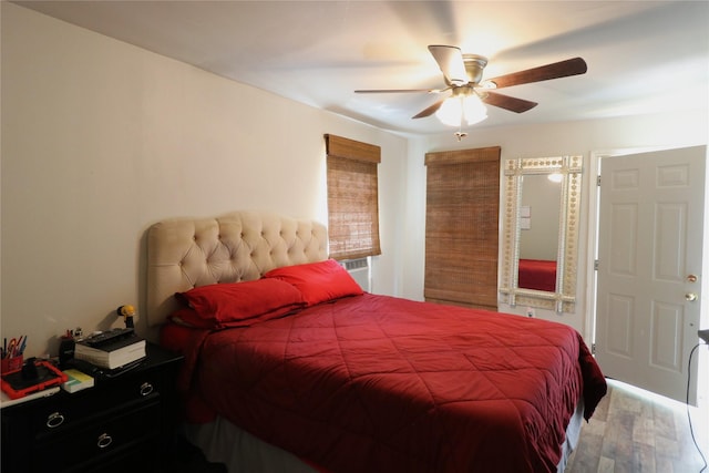 bedroom featuring cooling unit, ceiling fan, and wood finished floors
