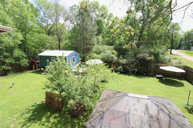 view of yard featuring an outdoor structure and a fenced backyard