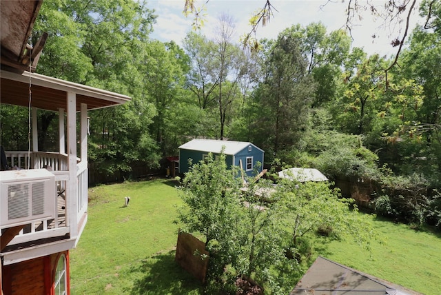 view of yard with fence and an outdoor structure
