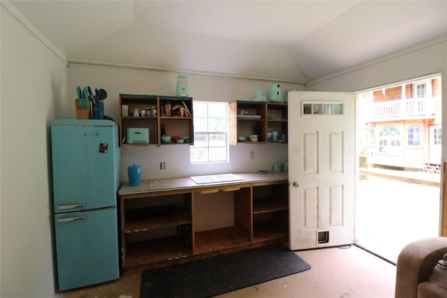 kitchen with freestanding refrigerator, vaulted ceiling, and open shelves