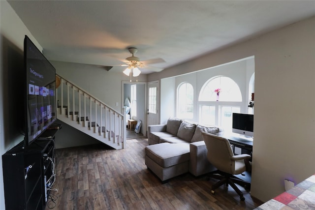 living area with dark wood finished floors, stairs, and ceiling fan