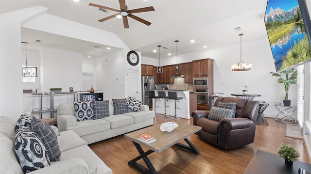living room featuring high vaulted ceiling, visible vents, wood finished floors, recessed lighting, and ceiling fan with notable chandelier