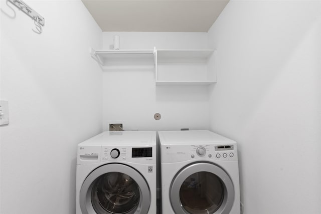 laundry room featuring washing machine and dryer and laundry area