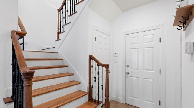 stairway with tile patterned floors