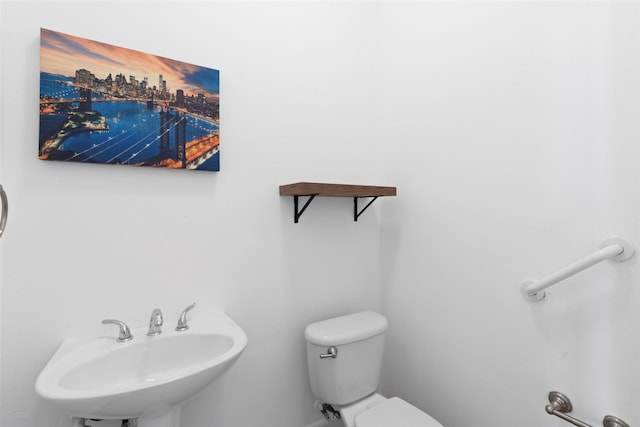 bathroom featuring toilet and a sink