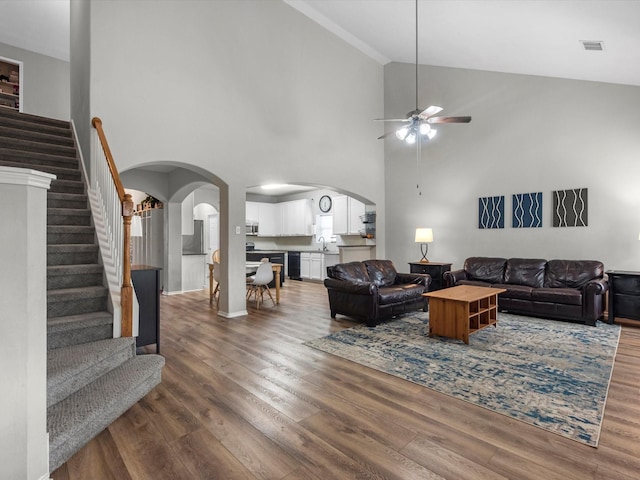 13923 Roanoke Falls Dr, Cypress, TX 77429 - living room with arched walkways, ceiling fan, stairway, wood finished floors, and high vaulted ceiling