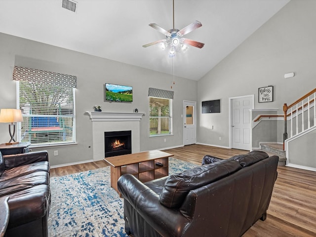 13923 Roanoke Falls Dr, Cypress, TX 77429 - living room featuring stairway, a ceiling fan, wood finished floors, a fireplace, and baseboards