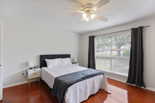 2120 El Paseo St Unit 1503, Houston, TX 77054 - bedroom with baseboards, a textured ceiling, wood finished floors, and a ceiling fan
