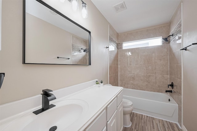 1218 Ventura Canyon Dr, Katy, TX 77494 - bathroom featuring vanity,  shower combination, toilet, visible vents, and wood finished floors
