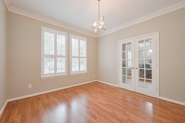 1218 Ventura Canyon Dr, Katy, TX 77494 - unfurnished room featuring a notable chandelier, crown molding, french doors, and light wood-style flooring
