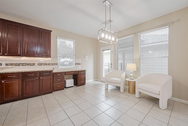 1218 Ventura Canyon Dr, Katy, TX 77494 - interior space featuring tasteful backsplash, light tile patterned floors, visible vents, baseboards, and pendant lighting