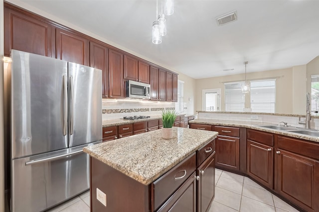 1218 Ventura Canyon Dr, Katy, TX 77494 - kitchen featuring backsplash, a kitchen island, appliances with stainless steel finishes, pendant lighting, and a sink