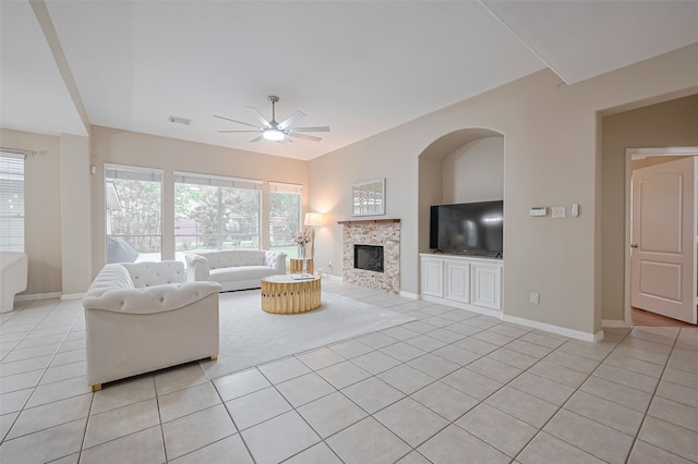 1218 Ventura Canyon Dr, Katy, TX 77494 - living area with baseboards, a tiled fireplace, light tile patterned floors, visible vents, and ceiling fan